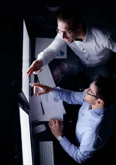 Top view business colleagues discussing information on the computer screenbusiness and technology