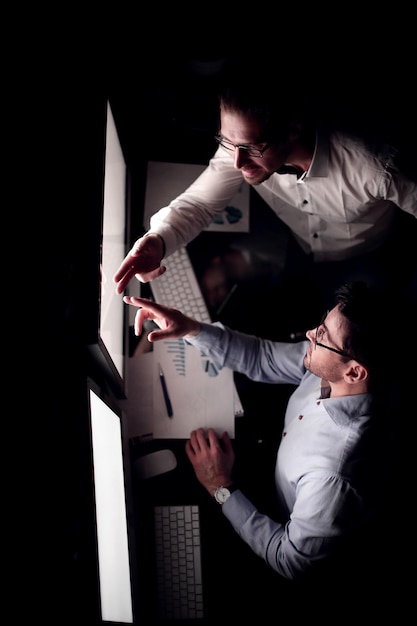 Top view business colleagues discussing information on the computer screenbusiness and technology