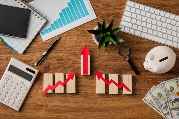 Top view of business items with growth chart and wooden cubes