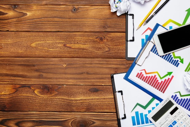 Top view of business paper chart or graph on wooden table