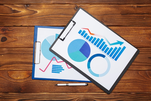 Top view of business paper graph on wooden table