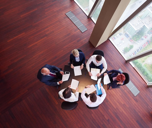 Top view of business people group on meeting throwing documents\
in air