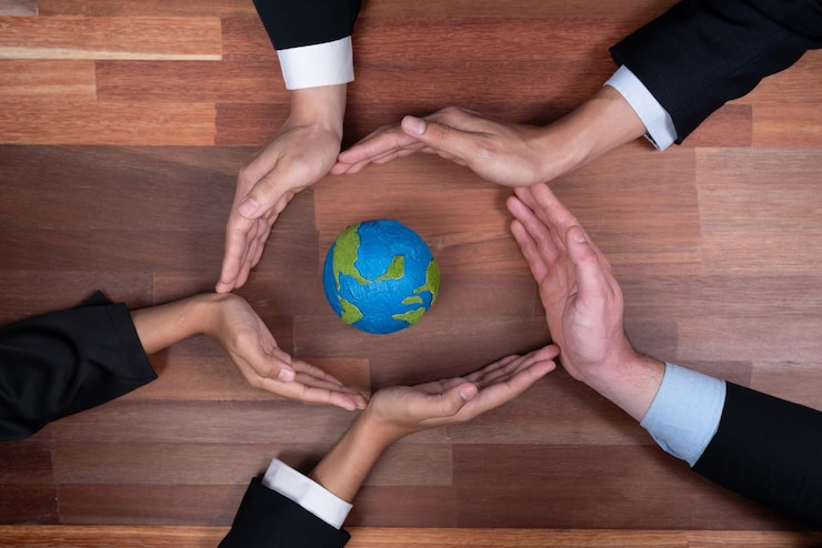 Photo top view business people holding earth together in synergy as team building to utilize eco regulation for environmental protection by reducing co2 emission to save earth quaint