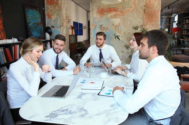 Top view of business people working together while spending time in the office.