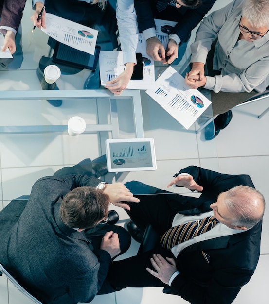 Top view business team discussing financial issues at a working meeting