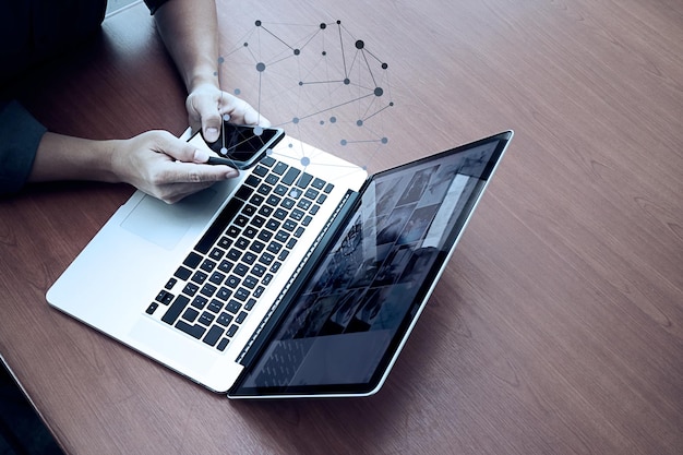 Top view of businessman hand working with new modern computer and smart phone and business strategy