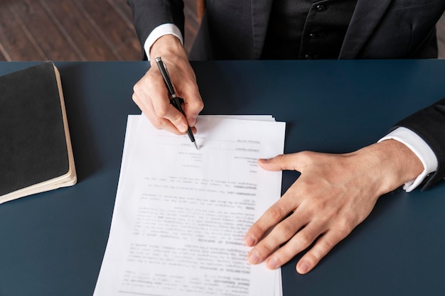 Top view of businessman hands signing contract