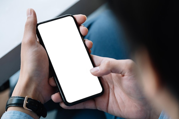 top view businessman sitting and holding blank screen mock up mobile phone
