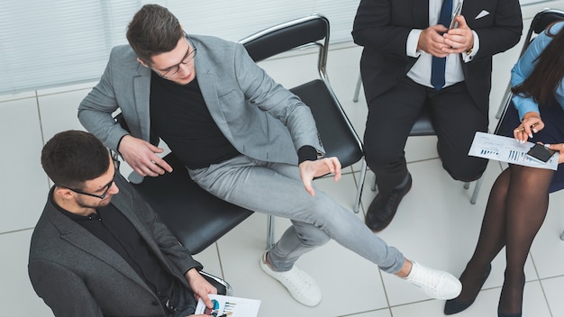 Top view businessman using a smartphone during a work meeting