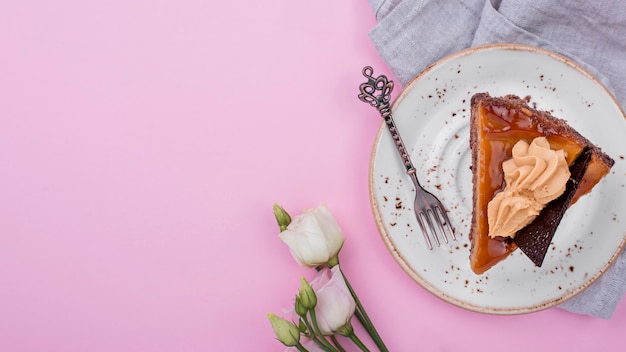 Top view of cake on plate with roses and copy space