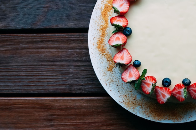 Top view cake with berries and white glaze