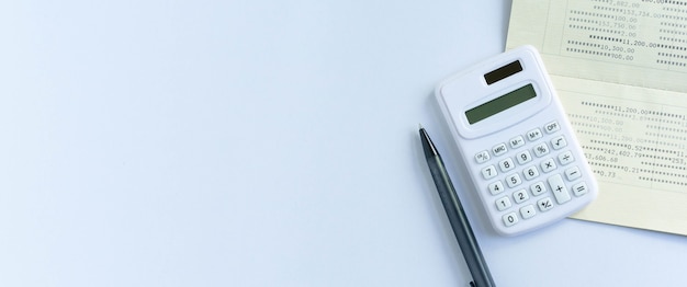 top view of calculator book bank and pencil for counting and planning about monthly expenses