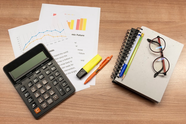 Top view calculator and paperwork on table in meeting room