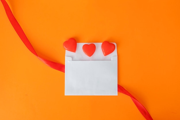 Top view of candies on an envelope and a ribbon