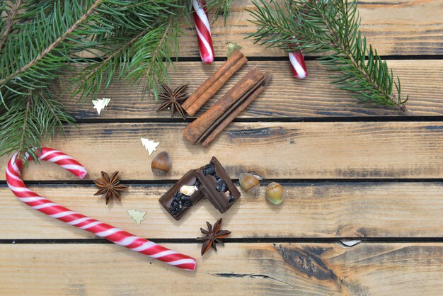 Top view on candy canes chocolate et spice on wooden in christmas decoration 