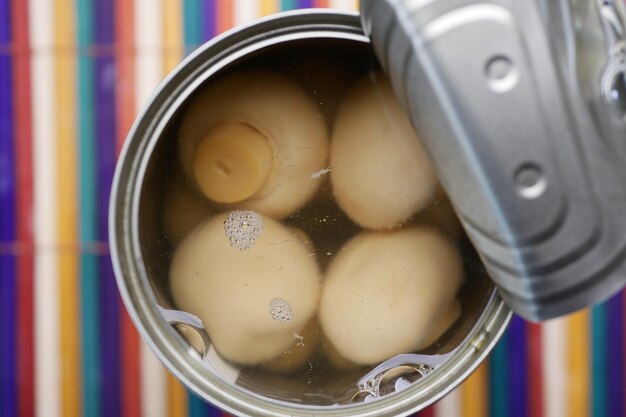 Top view of Canned mushrooms on table