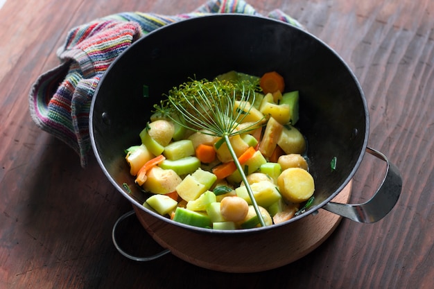 Top view of cauldron with hot stew of seasonal vegetables