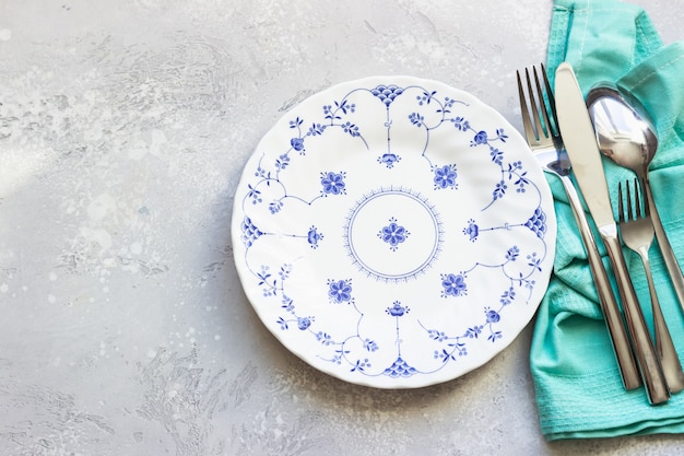 Top view of ceramic plate and silverware