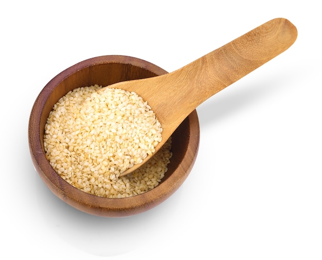 Top view of cereal dried food whole grains with white sesame seeds in wooden spoon on bowl isolated on white.