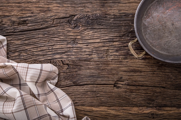 Top view of checkered tablecloth or napkin on empty wooden table