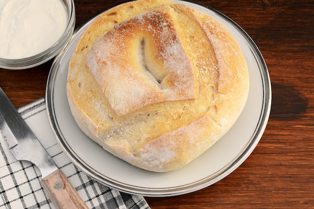 Top view of cheese bread with dip of cream cheese