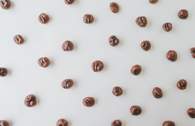 Top view of chestnuts on white wooden background