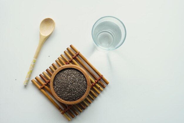 Top view of chia seeds and a glass of water