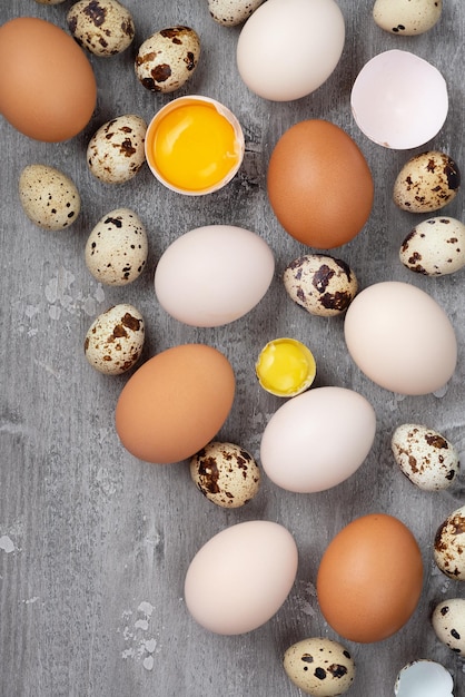 Top view of chicken and quail eggs on table