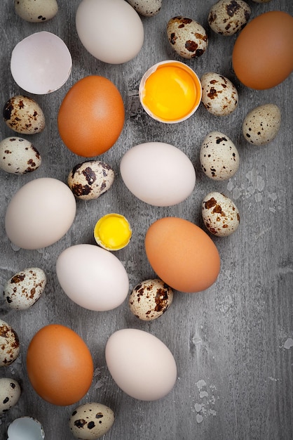 Top view of chicken and quail eggs on table