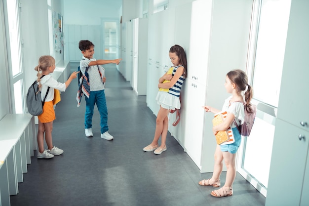 Photo top view of children bullying classmate at school