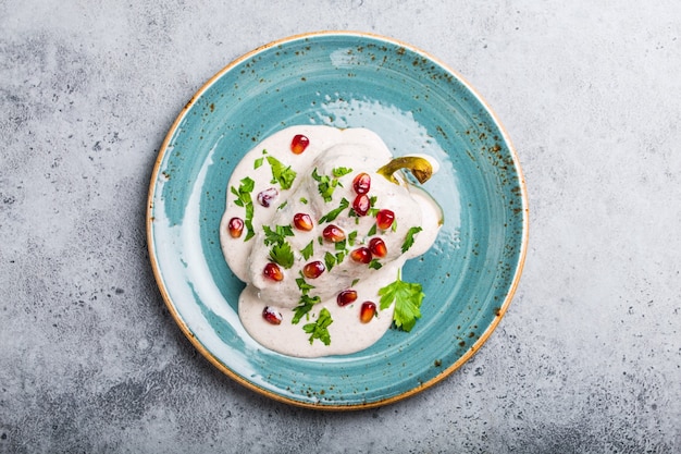 Top view of chiles en nogada, traditional festive dish on Mexican Independence Day. Green peppers chili with walnut sauce, appetizer usual for Mexico, for celebration and grand food fiesta