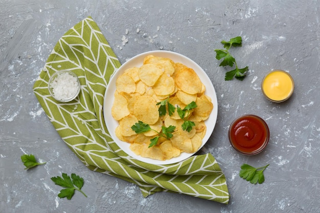 Top view chips with sause in bowl on colored background top view with copy space