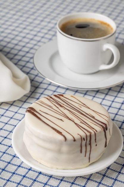 Top view of chocolate alfajores typical candy in Argentina on a checkered tablecloth