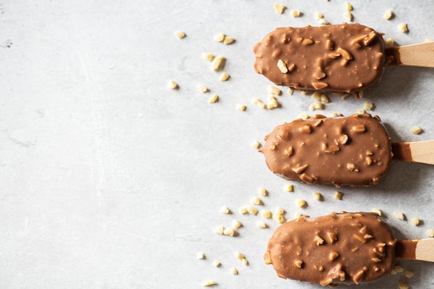 Top view of chocolate almond icecream on a wooden stick Copy space