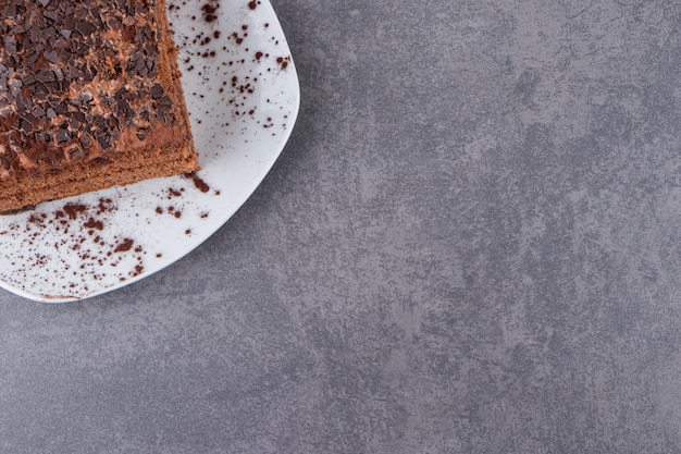 Top view of chocolate cake on plate over grey surface