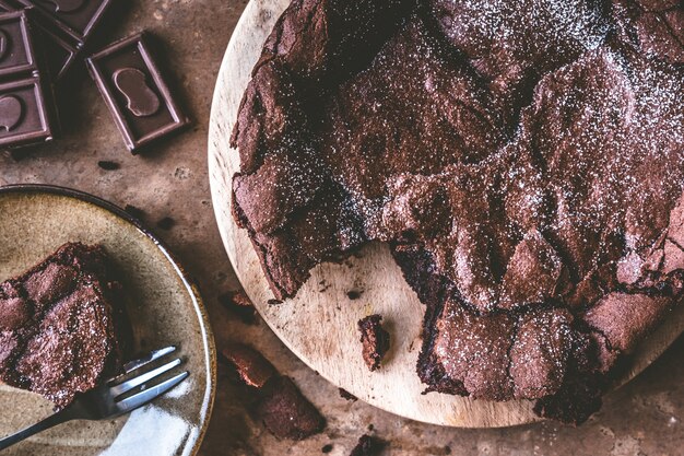 Top view of Chocolate cake on wooden tray with fork.