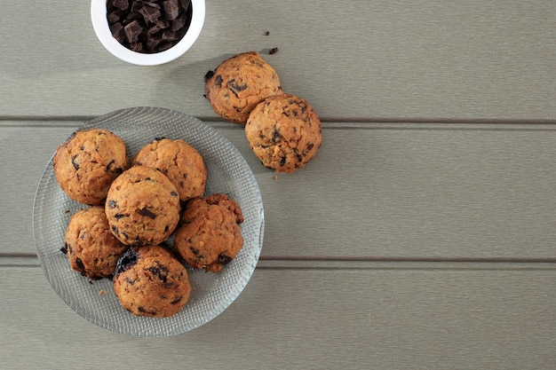 Top View Chocolate Chip Cookies Background with Copy Space on Gray Wooden Table. Homemade Food/Snack for Kids