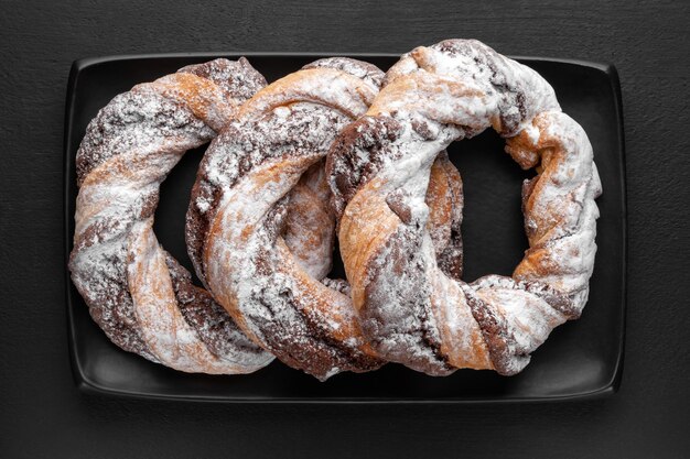 Top view chocolate cookie rings sprinkled with powdered sugar