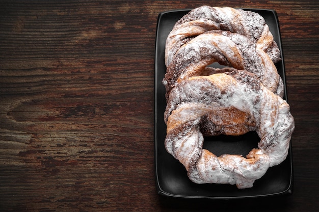 Top view chocolate cookie rings sprinkled with powdered sugar