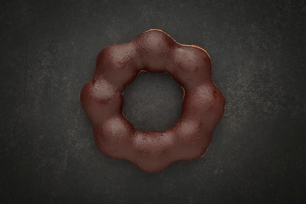 Photo top view of chocolate donut on dark gray, grey, black tone texture background with copy space