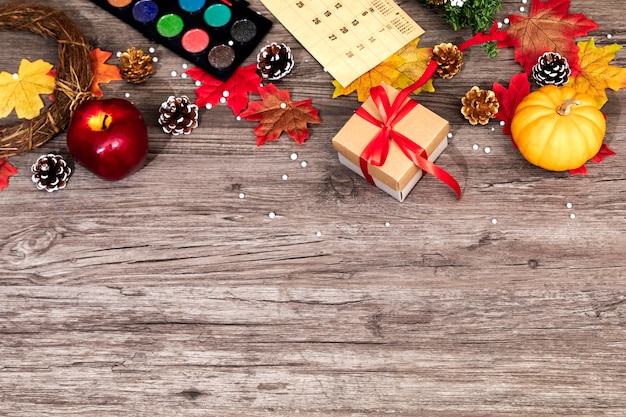 Top view of Christmas and autumn decorations on wooden desk