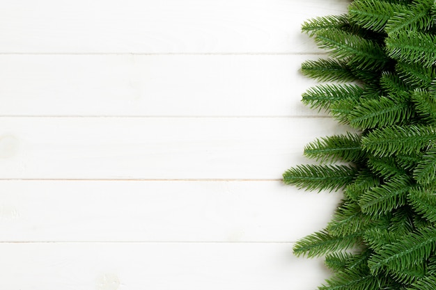 Top view of christmas background made of fir tree branches. new year concept with copy space on wooden background