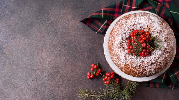 Photo top view of christmas cake with copy space and red berries