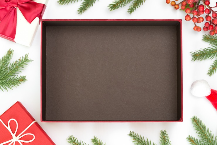 Photo top view of christmas composition, gift box, pine cones, fir branches and open the box with space to put product