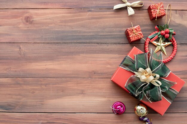 Top view of Christmas composition with gift boxes, ball on wooden background and copy space. Accessories of Christmas and new year concept.