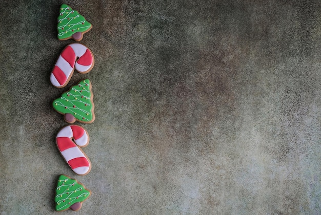 Top view of christmas cookies on gray background with space for christmas greetings gingerbread in t