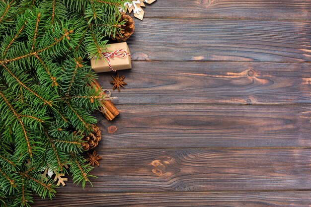 Top view of Christmas decoration with fir tree and gift box on wooden table