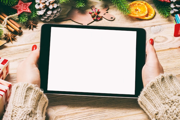 Top view christmas decorations with a tablet