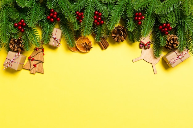 Top view of Christmas decorations on yellow background
