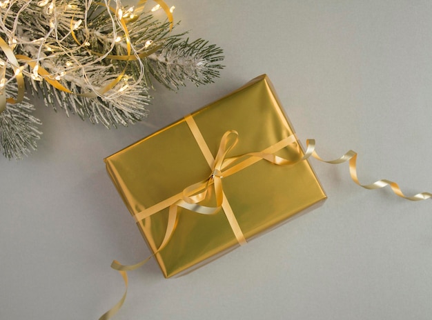 Top view of Christmas gold gift box on the gray background Closeup